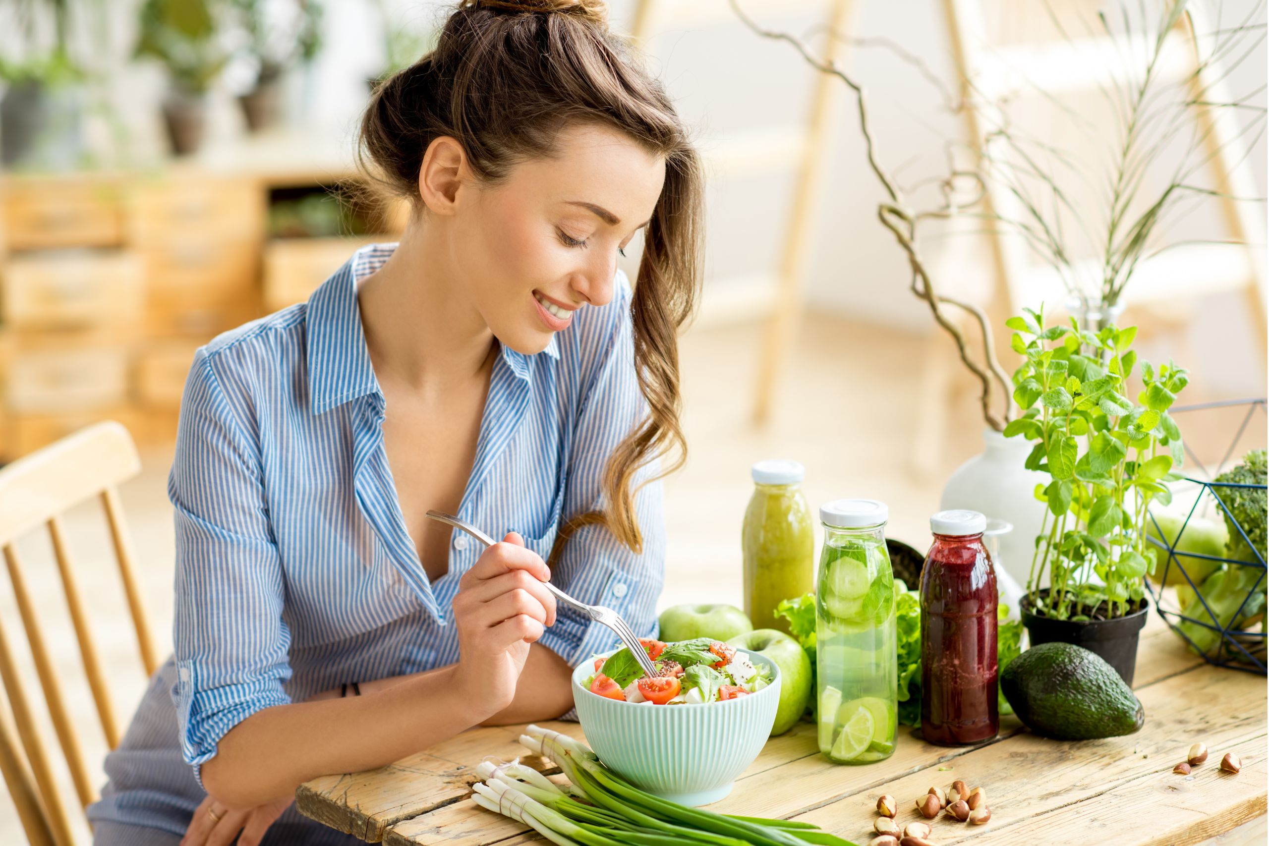 young happy woman eating healthy salad