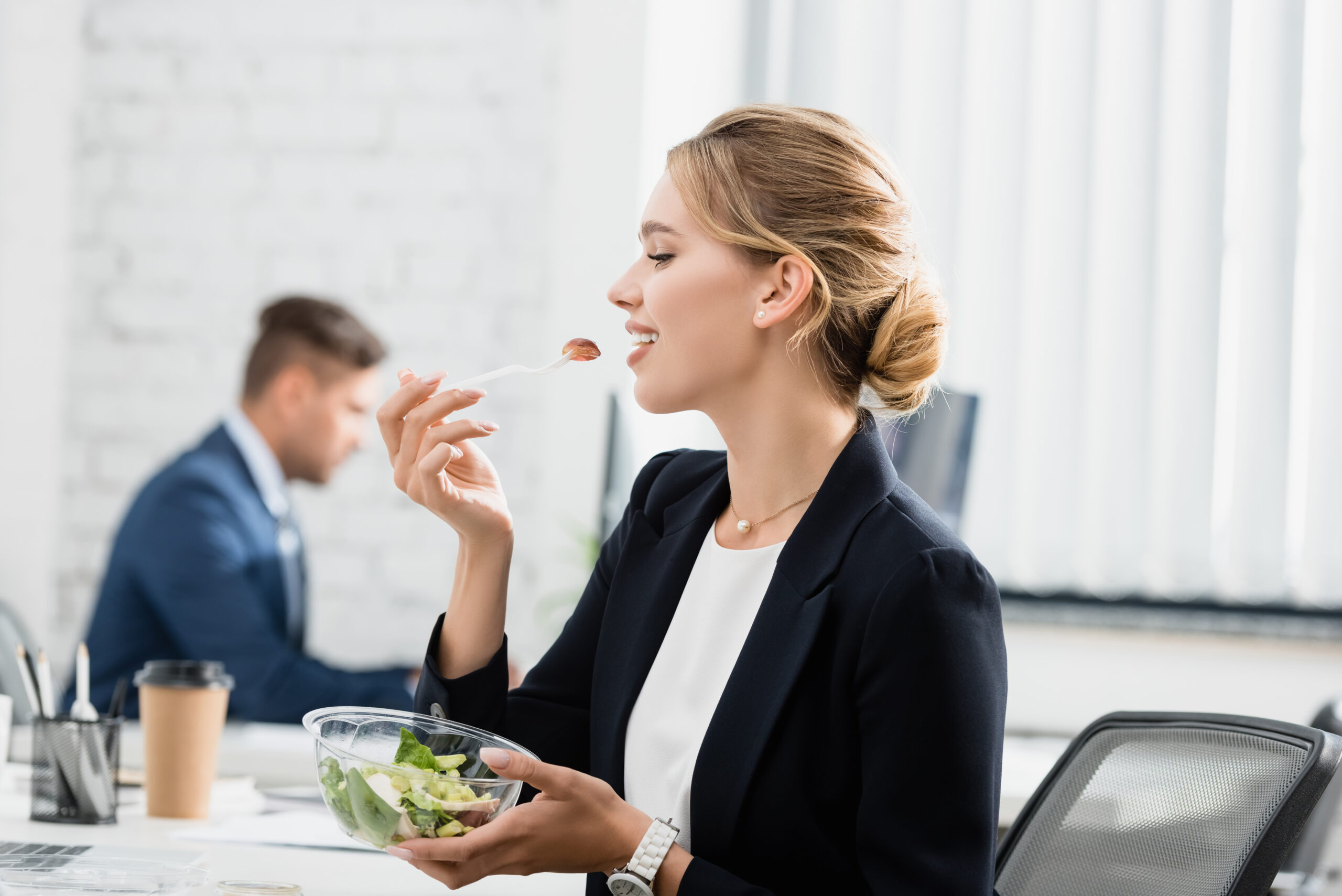 woman eating healthy food at the office